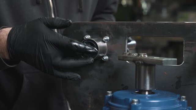 The engineer greases the bore before assembling the bearing unit, and then installs the shaft in the work area