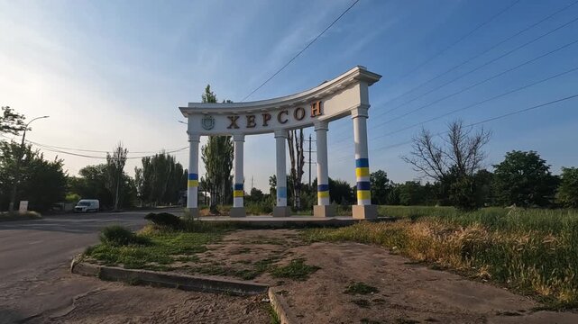 Volunteers arrived to entrance to arch of city Kherson to evacuate people and animals after destroyed Kakhovka dam. Rescue workers riding to help as result of explosion on Hydroelectric Power Station