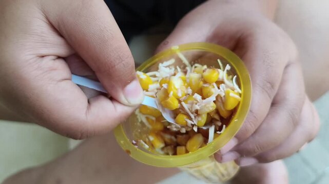 A child Eating Sweet corn 