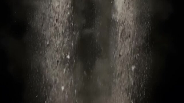 Dirt debris falling with brown dust clouds on black background isolated