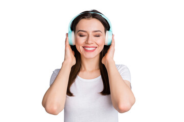 Fototapeta premium Portrait of positive cheerful youth girl hold wireless headset listen disco style music feel content face expression wear good look clothes isolated over gray color background