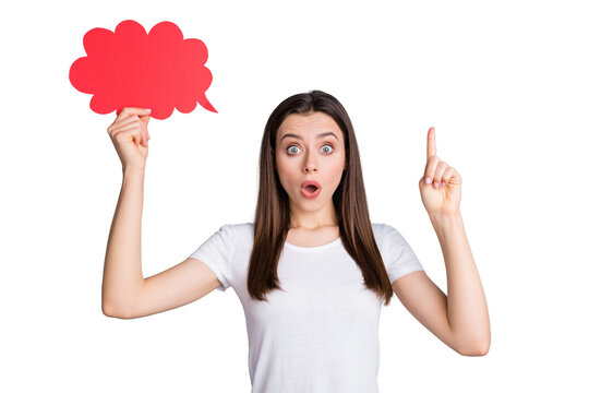 Portrait of astonished girl hold red paper card speech bubble get incredible idea raise index finger up impressed wear good look clothes isolated over gray color background
