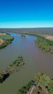 Aerial view of the confluence of the Vaal river and the Orange river south of the town of Douglas, Northern Cape, where brown and green river water merge.  Vertical image