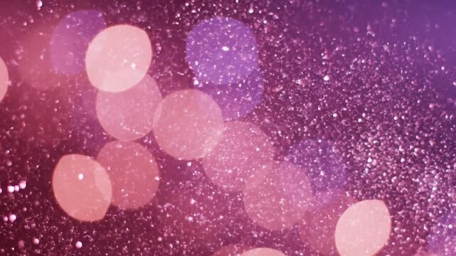 Shimmering pink bokeh circles and magical glitter particles floating on a soft purple background
