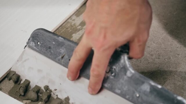 Home Renovation Contractor Laying Ceramic Tiles With Mortar
