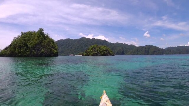 slow motion of still view look out to shallow blue green turquoise peaceful lagoon from a small boat to coral rocks at Siete Pecados Marine Park Coron Philippines during sunny blue sky good day 