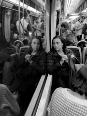 Woman observing her reflection on subway ride © virginia