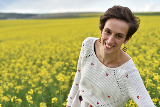 Laughing woman in a canola field