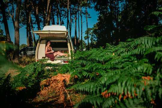 Man Relaxing in Open Vintage Campervan in Pine Forest &ndash; Van Life Lifestyle