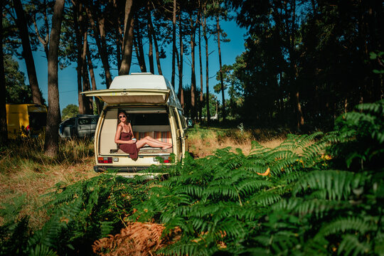 Man Relaxing in Open Vintage Campervan in Pine Forest &ndash; Van Life Lifestyle