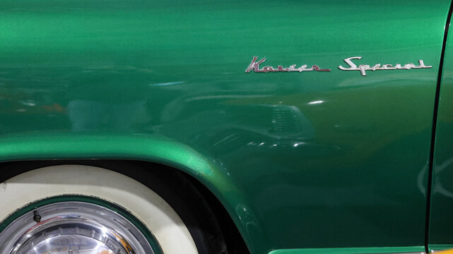 Perth, Western Australia, Australia - May 3 2026: Side view, green 1954 Kaiser Manhattan. Shiny chrome kaiser special script badge emblem, whitewall tire, wheel cap, fender panel