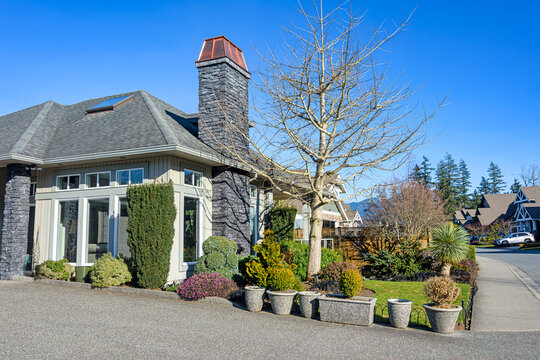 Large Grey Suburban House with Mountain View and Clear Blue Sky