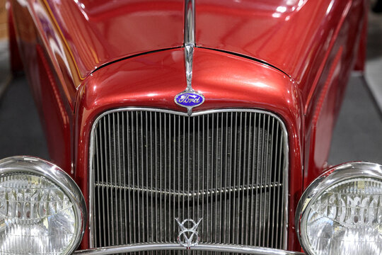 Perth, Western Australia, Australia - May 3 2026: Close detail, classic red 1932 Ford Tudor. Iconic chrome grille shell, vertical grill bars, v8 badge emblem, vintage headlights