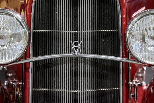 Perth, Western Australia, Australia - May 3 2026: Close detail, classic red 1932 Ford Tudor. Iconic chrome grille shell, vertical grill bars, v8 badge emblem, vintage headlights