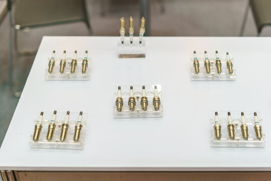 Automotive Engine Spark Plugs on Display Stands