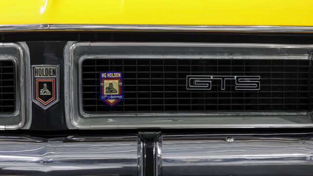 Perth, Western Australia, Australia - May 3 2026: Classic Australian muscle car front grille. Holden lion badge alongside GTS lettering. Vintage yellow classic automobile, iconic Ford rival era