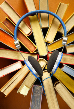 audiobooks concept with books and headphones.
