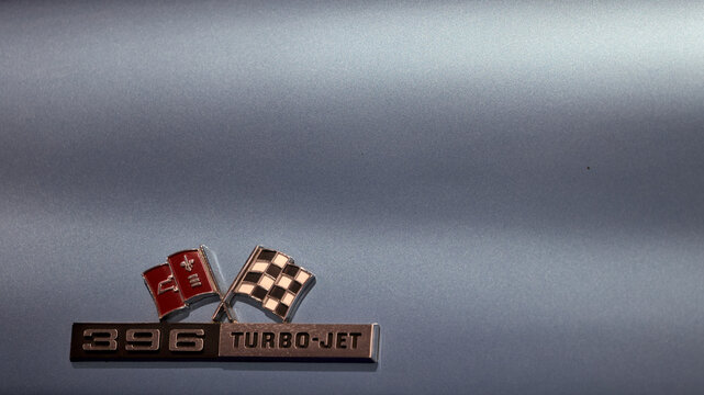 Perth, Western Australia, Australia - May 3 2026: Classic 1965 Chevrolet C2 Corvette Stingray silver body panel. Crossed flags 396 turbo-jet emblem badge. Iconic american vintage muscle sports car