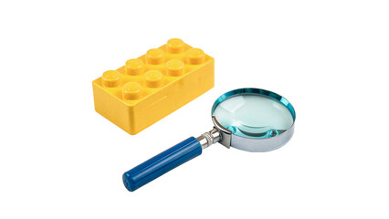 Yellow plastic building block lego brick with magnifier isolated on transparent background © Hanna