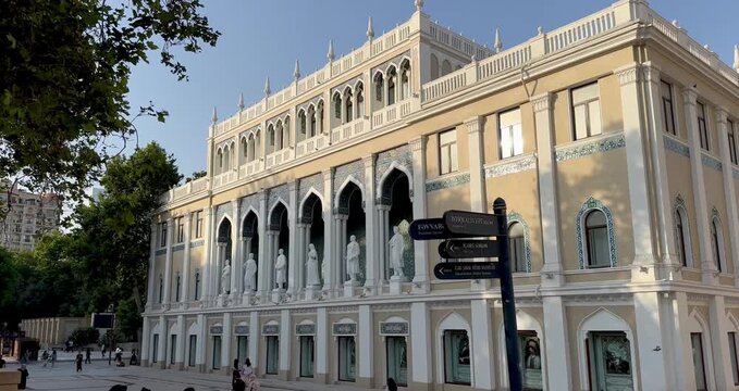 Nizami Museum of Azerbaijani Literature facade in Baku, Azerbaijan with statues and street sign