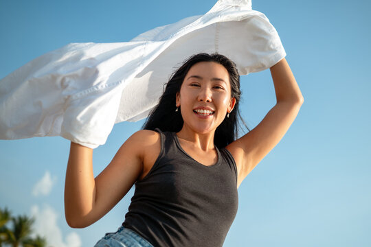 Carefree traveler feeling secure and protected while enjoying a dream vacation at a tropical beach