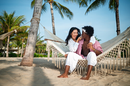 Pure happiness. A young diverse, multiethnic couple enjoys every moment of their tropical getaway