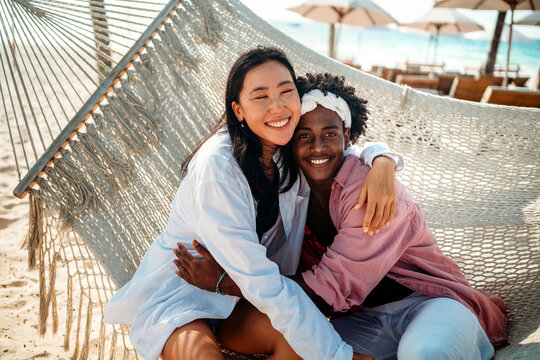 Pure happiness. A young diverse, multiethnic couple enjoys every moment of their tropical getaway