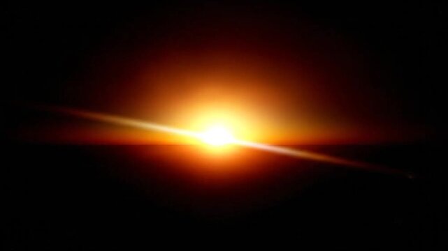 A bright sun rises over a dark horizon with a dramatic lens flare effect