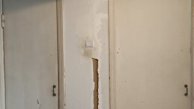 Old interior room doors with damaged wood and peeling paint