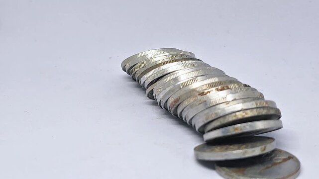 Row of coins falling horizontally dow with rack shoot 