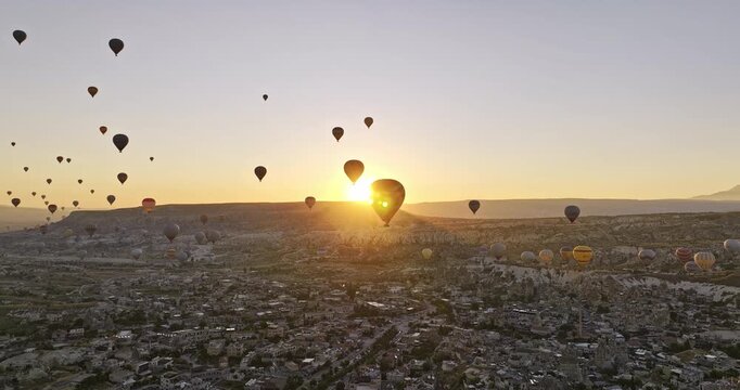 G�reme Turkey Aerial v57 magical landscape view of volcanic rock formations with glowing sun rising up above Mesa tabletop mountain against the Cappadocian horizon - Shot with Mavic 3 Cine - July 2022