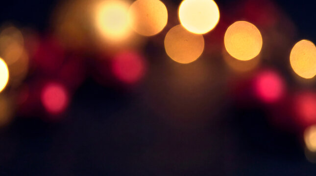 Dark festive bokeh lights background in gold and red for a Black Friday sale design