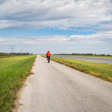 cyclist is riding a gravel touring bike - biking on a levee trail along Chain of Rocks Canal near Granite City in Illinois