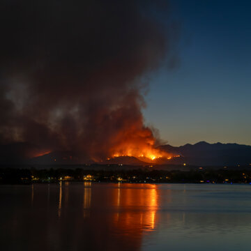wildfire at Colorado foothills west of Loveland, smoke plume from Mount Alexander fire as seen at sunset from Boyd Lake, July 29, 2024