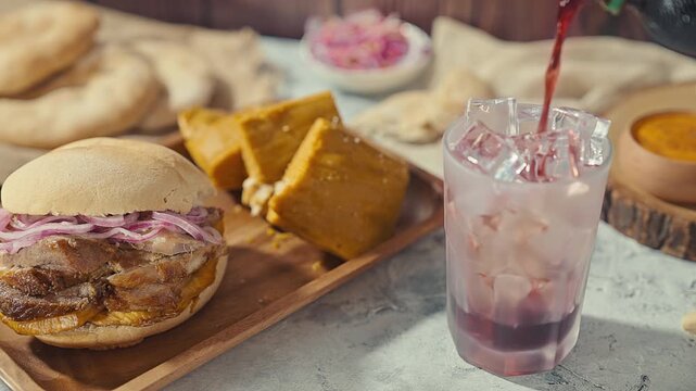 Traditional Peruvian Breakfast with Chicharron Sandwich Tamales and Chicha Morada