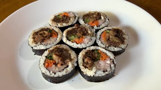 4K Top View Video of Korean Bulgogi Kimbap Rice Rolls with Beef and Vegetables for Korean Cuisine and Food Documentary Footage