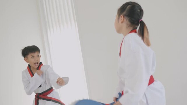 Children practicing martial arts skills in a training session in a dojo