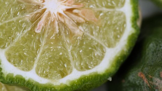 Rotating Close-Up of Sliced Kaffir Lime Half, bergamot herb