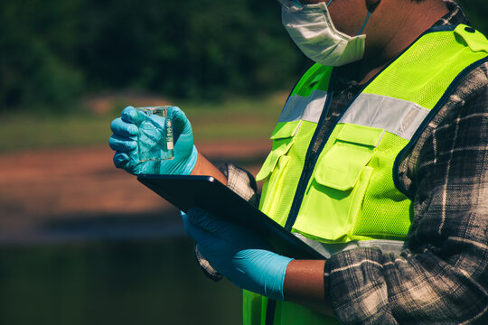 Scientists performing water sample collection for environmental testing and pollution assessment.