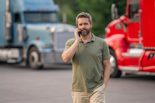 Mobile communication. Mature man driver of truck talk on phone. Professional trucker. Truck driver has phone call. Man trucker driver at lorry truck. Semi trucks vehicle. Hispanic man trucker
