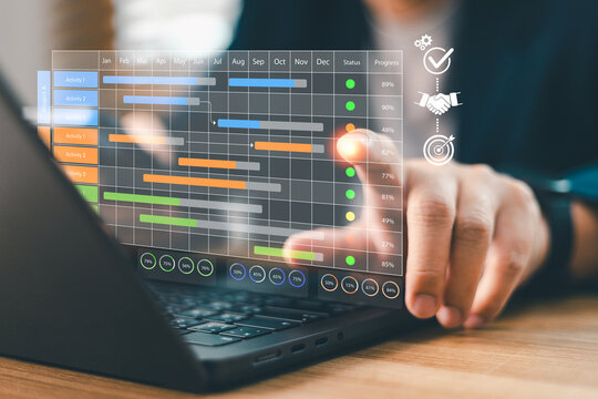 Businessperson using laptop with virtual Gantt chart schedule planning dashboard for project management, tracking timeline, progress workflow, team milestone and corporate strategy concept