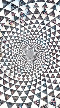Seamless vertical video of a black and white mandala pattern swirl. Geometric graphic spiral with a psychedelic look.