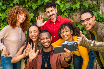 Fototapeta premium Diverse smiling people taking a group selfie video together
