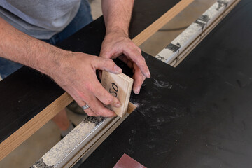 Hands sanding a surface craftsman renovation work © Thomas