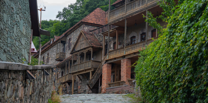 Panoramic Old Dilijan cobblestone street with traditional carved wooden balconies