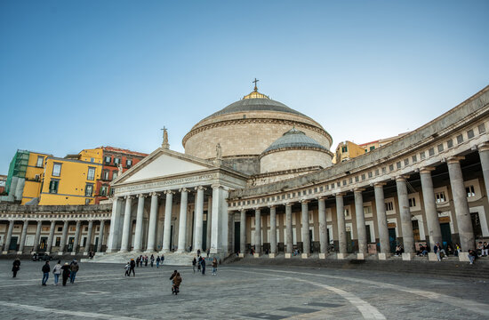 Naples, italy. December 27, 2024. Tourists visiting piazza del plebiscito, a large public square in naples, italy, with the neoclassical church san francesco di paola