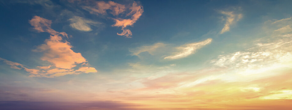 Beautiful sunset sky background with dramatic deep blue clouds and bright golden orange sun glow for panoramic travel mockup design