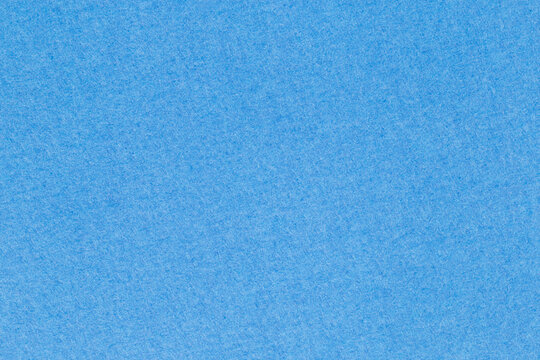 sky blue backdrop: close up of dense matte craft paper surface