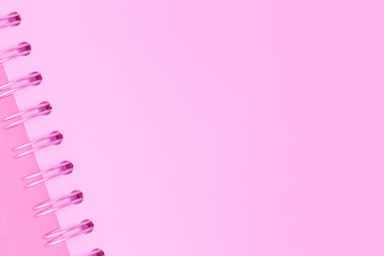 pink color backdrop: blank page of sketchbook with metallic binder
