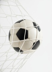 Naklejka premium Close up of a classic soccer ball in the net isolated on white background.